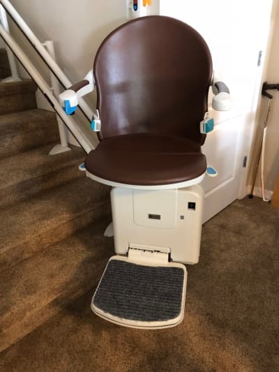Curved stairlift installation on wooden staircase in Salt Lake City home