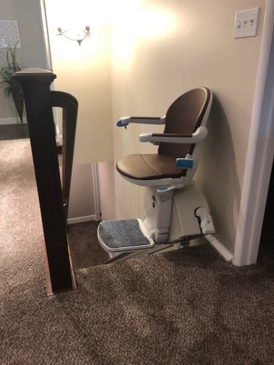 Professional stairlift installation with handrail integration