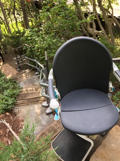 Completed curved stairlift installation with happy homeowner